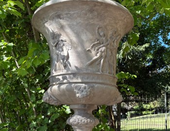 Stone planter with ornate motifs in the garden of Villa Pétrusse in Luxembourg City.