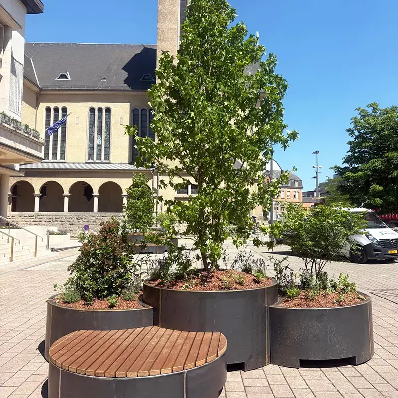 Planters that combine greenery with well-crafted wooden benches for residents of the Luxembourg town of Schifflange.
